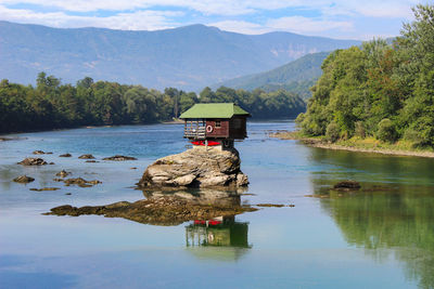 Scenic view of lake and mountains against sky