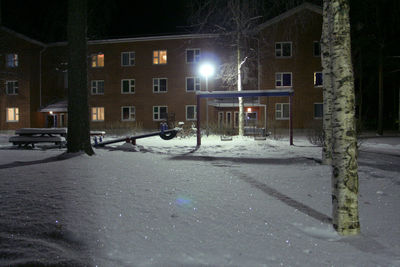 Illuminated street lights in city during winter