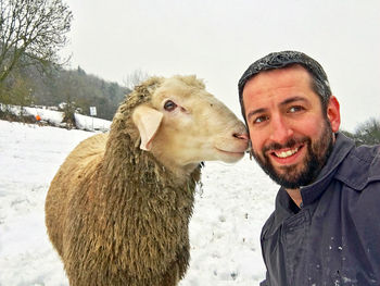 Portrait of smiling young woman with snow