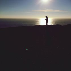 Silhouette of people standing on beach