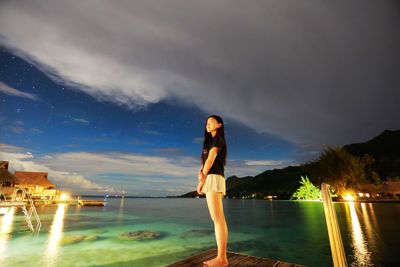 Portrait of young woman standing in swimming pool