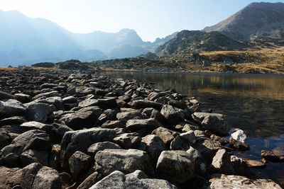 Scenic view of lake and mountains against sky