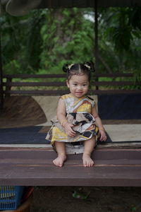 Portrait of a girl sitting outdoors