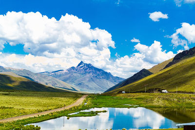 Scenic view of lake and mountains against sky