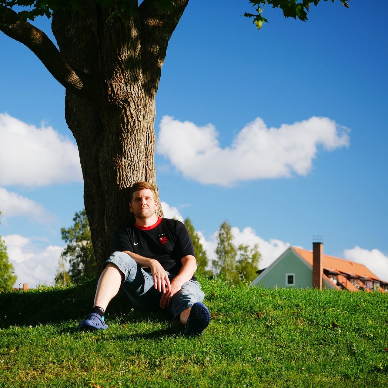 grass, lifestyles, sky, leisure activity, tree, casual clothing, field, grassy, day, green color, outdoors, cloud - sky, relaxation, nature, growth, portrait, lawn