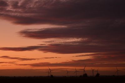 Scenic view of silhouette field against sky during sunset