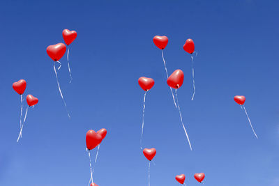 Low angle view of balloons against clear sky