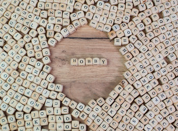 Directly above shot of hobby text amidst wooden cubes