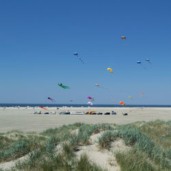 Scenic view of beach against clear blue sky