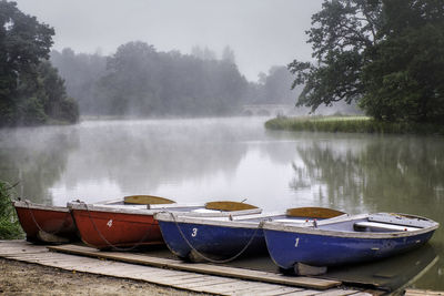 Boats moored in lake