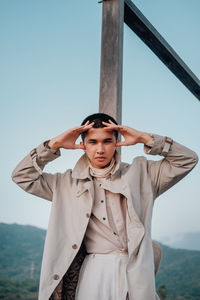 Full portrait of a young man standing in the field