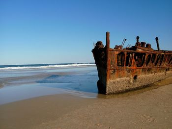 Abandoned boat on shore