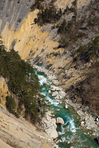 High angle view of stream flowing through rocks