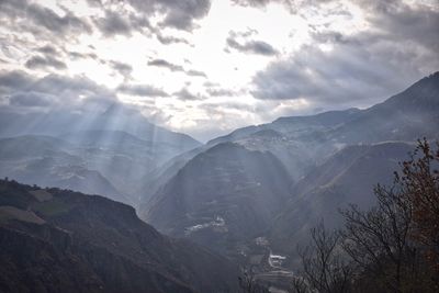 Scenic view of dramatic landscape against cloudy sky