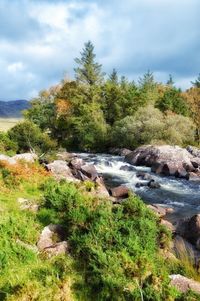 Scenic view of waterfall against sky
