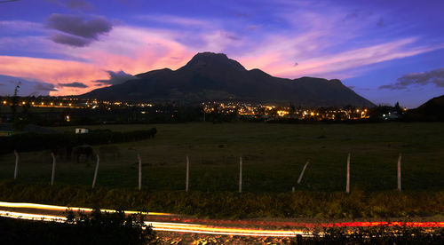 Illuminated landscape against sky