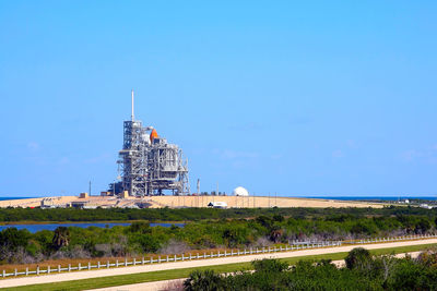 View of bridge and buildings against blue sky