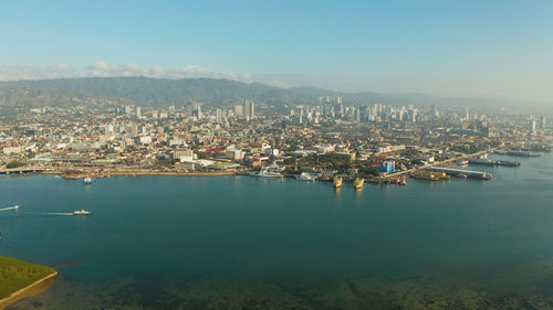 Aerial view of panorama of cebu city with skyscraper, buildings and seaport with ships and ferries