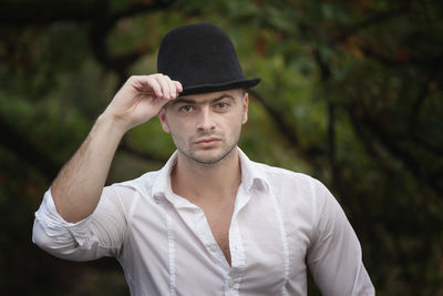 Young man wearing hat standing outdoors