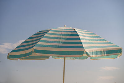 Low angle view of parasol against sky