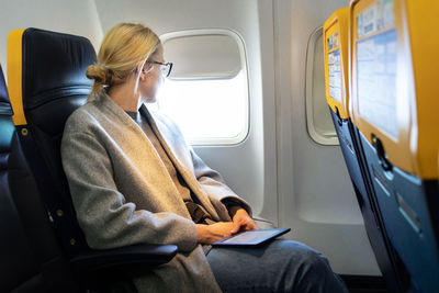 Rear view of woman sitting in train