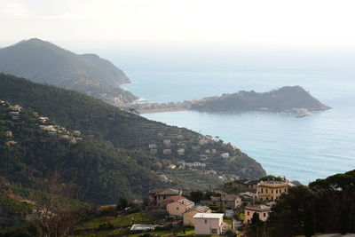 High angle view of townscape by sea against sky