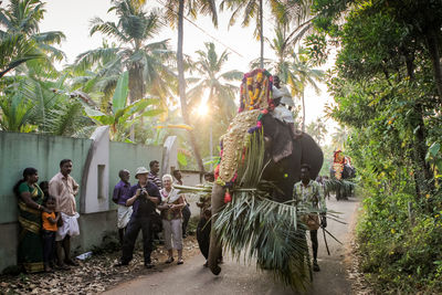 Group of people by palm trees