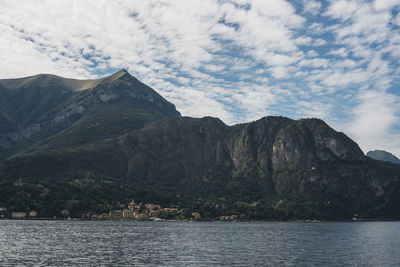 Scenic view of sea and mountains against sky