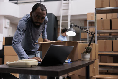 Young man using laptop at office