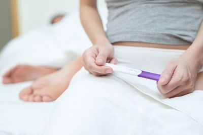 Close-up of baby girl lying on bed