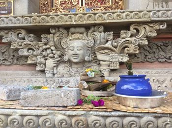 Buddha statue against wall of building