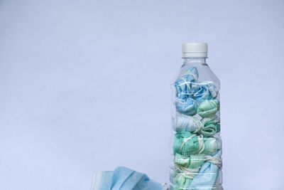 Close-up of glass bottle against blue background