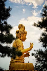 Low angle view of statue against sky