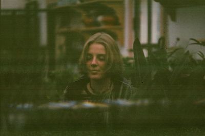 Young woman with reflection in mirror