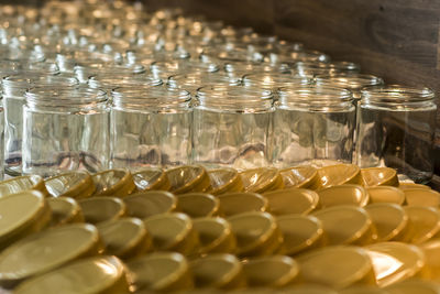 Close-up of jars and lids arranged on table