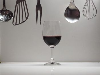 Wineglass with kitchen utensils