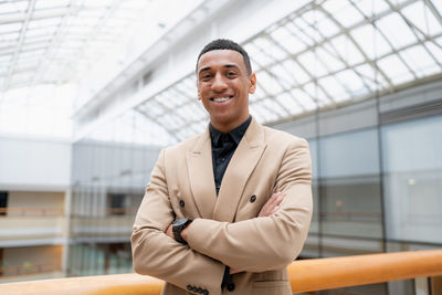 Portrait of young man standing in city