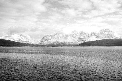 Scenic view of lake against cloudy sky