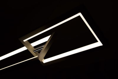 High angle view of illuminated lighting equipment in darkroom