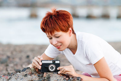 Side view of young woman using mobile phone