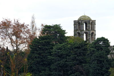 View of trees and building against sky