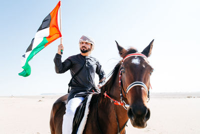 Man with horse on desert