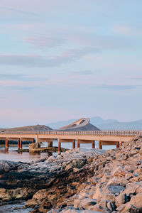 Gazebo on beach against sky during sunset