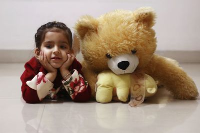 Portrait of cute girl with toy at home