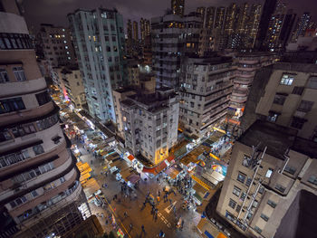 High angle view of people on city street amidst buildings