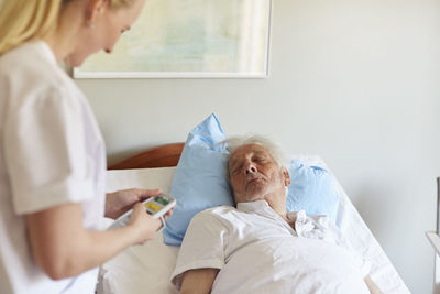 Midsection of woman lying on bed