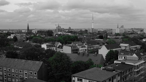 Cityscape against cloudy sky