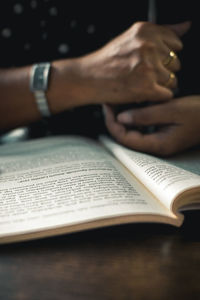 Midsection of woman reading book