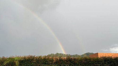 Rainbow over landscape against sky