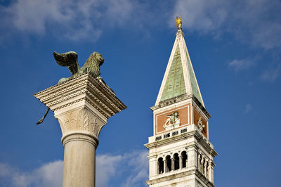 Low angle view of monument and san marco campanile against blue sky